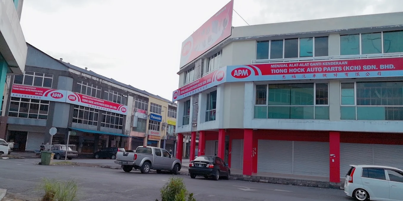 Multi-storey Tiong Hock Auto Parts building with red and white signage along the street